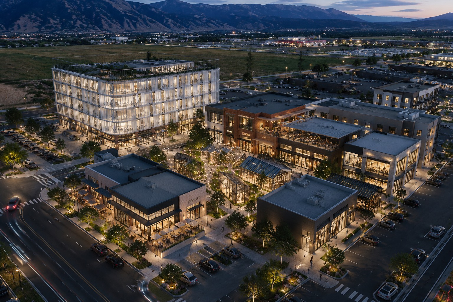 Evening aerial rendering of a mixed-use development — offices, shops and restaurants around a lit courtyard, with the Wasatch Range behind.